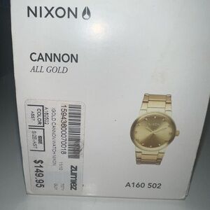 Nixon- Gold in color watch.